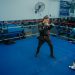 Boxers sparring in a gym in Buenos Aires, focusing on technique and endurance.